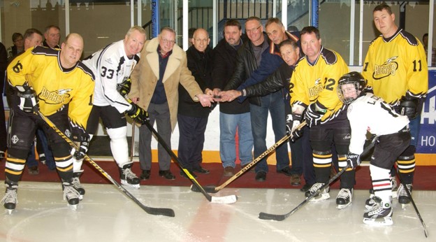 NHL alumni ceremonial puck drop at a community hockey event